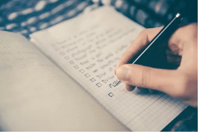 A person writing in a notebook