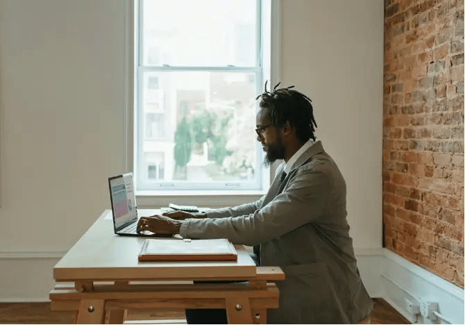 Man in a suit working on laptop