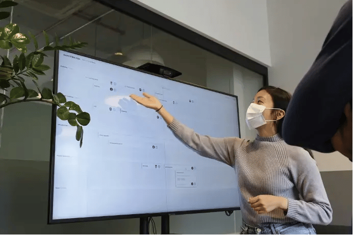 Woman with surgical mask gives a presentation