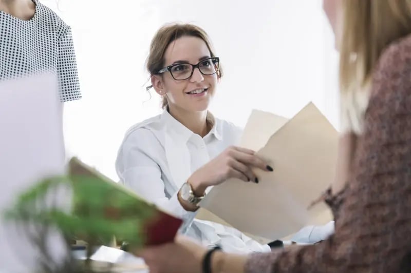 Smiling business woman holding a folder